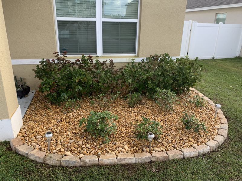 Curved river-rock bed wrapping to the front step.